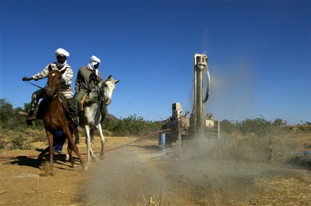 Two men on horses, and a drill in action