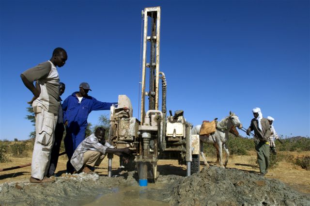 Men drilling for water